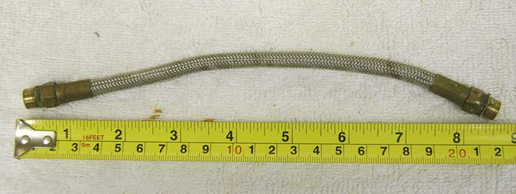 Brass stainless braided line, 8.75 used with wrench marks,