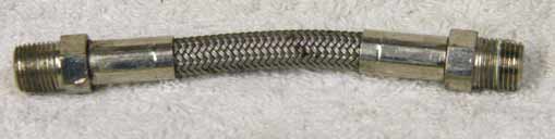 4” steel braided hose, used shape, wrench marks on ends