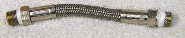4.125 to 4.25 inch steel braided hose, bad used shape, wrench marks on ends