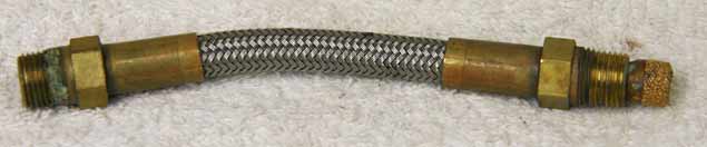 4.125” steel braided hose, used good shape, has screw in filter, has brass ends