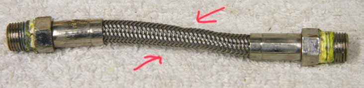 4.5” steel braided hose, used shape, wrench marks on ends