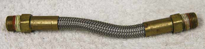 4.5” steel braided hose, used decent shape, brass ends