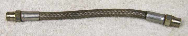 6.75 to 7 inch steel braided hose, bad shape, dirty but should still work fine