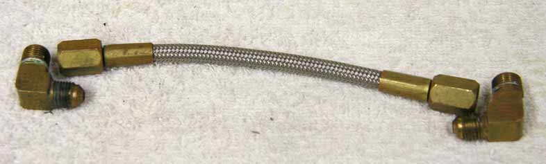 7” steel braided hose, brass with tighten to seal fitting on both ends, measured end to end, used good shape