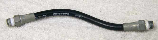 Old 6.75” black plastic hose, 2500psi rated would not recommend over 800 psi, used decent shape, has bend to it