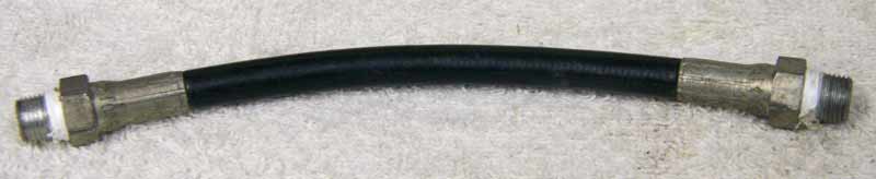Old 6.5” black plastic hose, 2500psi rated would not recommend over 800 psi, used decent shape, has wrench marks