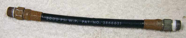 Old 6.5” black plastic hose, 2500psi rated would not recommend over 800 psi, used decent shape, ends have rust