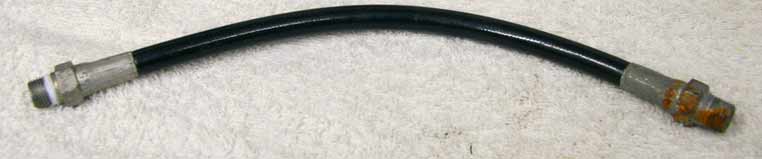 Old 9” black plastic hose, 2500psi rated would not recommend over 800 psi, good shape, ends have rust