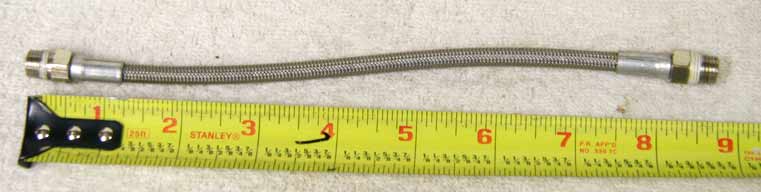 8.75 to 9 inch steel braided hose, used good shape, light wrench marks