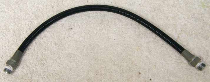 Old 12.5” black plastic hose, 2500psi rated would not recommend over 800 psi, good shape, ends are lightly corroded