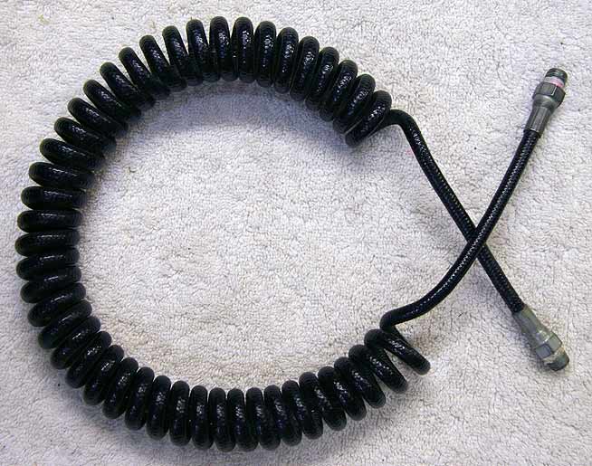 black coiled remote, thick plastic line, 29 inch