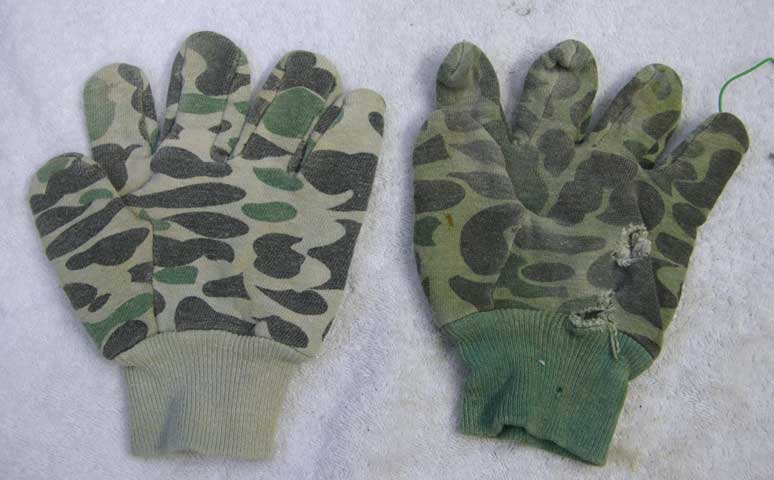 Two left hand gloves in camo