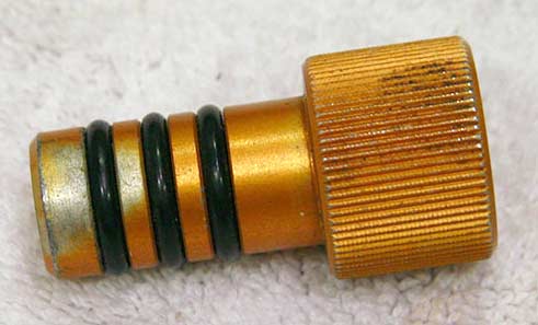 Orange anodzied barrel plug with some wear
